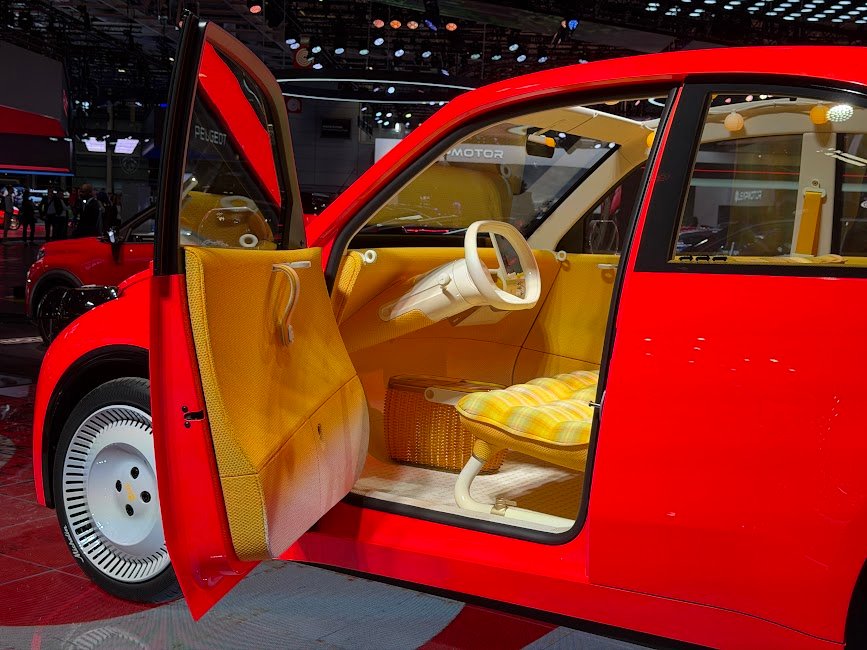 Porte ouverte sur la banquette jaune à carreaux et les rangements de la 2 CV Concept